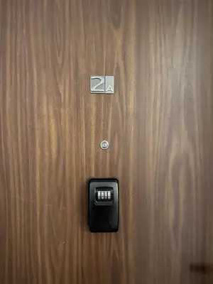 an alarm clock is on a wooden door at Centrum Apartamenty Stare Miasto in Kraków