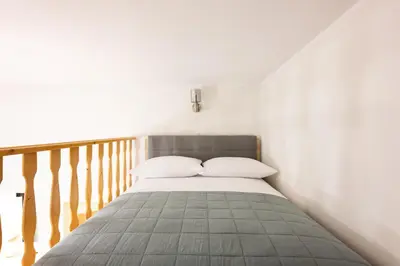 a bed with two pillows on it in a bedroom at Native Apartments Dietla 17 in Kraków