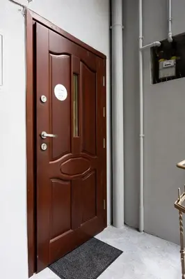 a wooden door in a room with a rug at Native Apartments Dietla 17 in Kraków