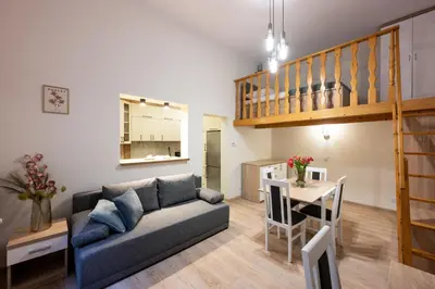 a living room with a couch and a table at Native Apartments Dietla 17 in Kraków