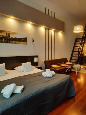 a hotel room with two beds and a staircase at Luxury Senate Apartment in Kraków