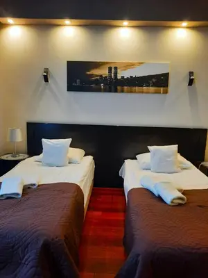 two beds sitting next to each other in a room at Luxury Senate Apartment in Kraków