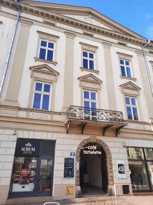 a large white building with a balcony on it at Luxury Senate Apartment in Kraków
