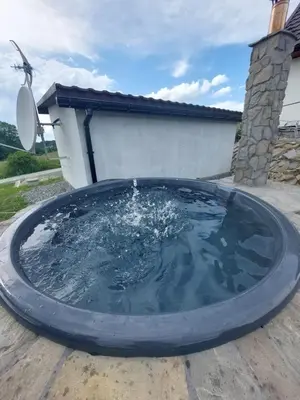 a large pool of water in a backyard at Skalne Rancho - BALIA, MASAŻ in Rabka-Zdroj