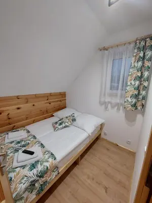 a small bedroom with a bed and a window at Skalne Rancho - BALIA, MASAŻ in Rabka-Zdroj