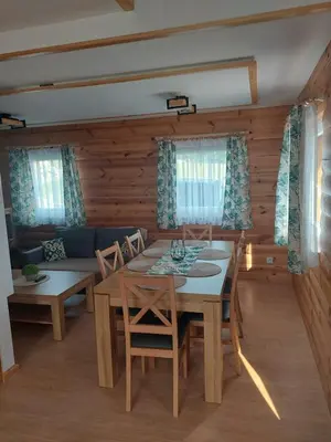 a dining room with a table and a couch at Skalne Rancho - BALIA, MASAŻ in Rabka-Zdroj