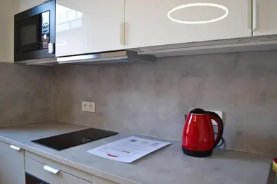 a red tea kettle on a counter in a kitchen at Tutu Kraków in Kraków