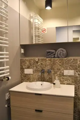 a bathroom with a sink and a mirror at Tutu Kraków in Kraków