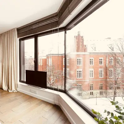 a room with a large window looking out at a building at PANORAMA VIEW by MINT APARTMENT in Kraków