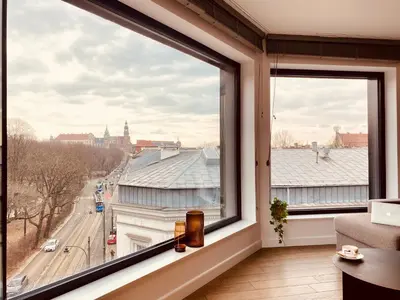 a room with a large window with a view of a city at PANORAMA VIEW by MINT APARTMENT in Kraków