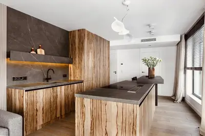 a kitchen with wooden cabinets and a sink at PANORAMA VIEW by MINT APARTMENT in Kraków