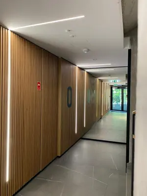 a hallway in a building with wooden walls at Lux Stays by Torres at K39 Krakow in Kraków
