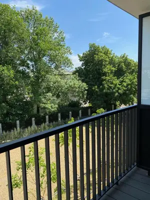 a balcony with a view of the cemetary at Lux Stays by Torres at K39 Krakow in Kraków