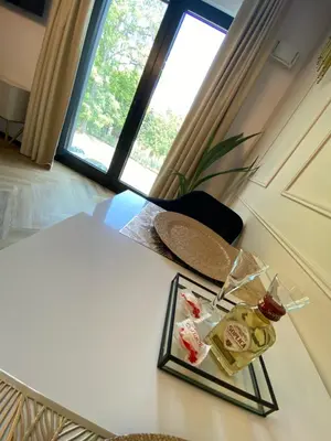 a plate of food on a table with a window at Lux Stays by Torres at K39 Krakow in Kraków