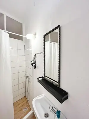 a bathroom with a sink and a mirror on the wall at Cozy studio in Cracow in Kraków