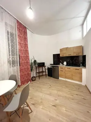 an empty living room with a table and chairs at Cozy studio in Cracow in Kraków