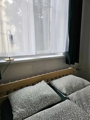 a bedroom with two beds and a window at Cozy studio in Cracow in Kraków