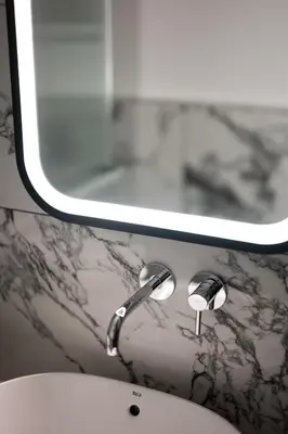 a bathroom with a sink and a mirror at Native Apartments Kościuszki 39 in Kraków