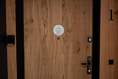 a wooden door with a sticker on it at Native Apartments Kościuszki 39 in Kraków