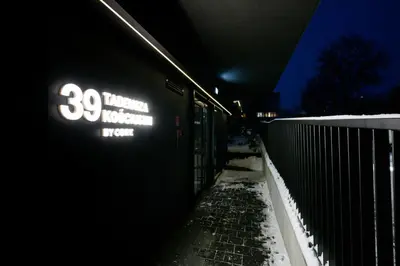a train parked next to a fence in the snow at Native Apartments Kościuszki 39 in Kraków