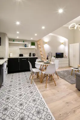 a kitchen and living room with a table and chairs at Bocheńska 6 by Homeprime in Kraków