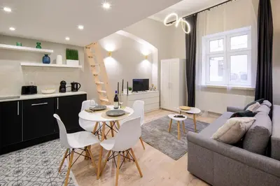 a living room with a couch and a table and chairs at Bocheńska 6 by Homeprime in Kraków