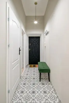 a hallway with a green bench in front of a door at Bocheńska 6 by Homeprime in Kraków