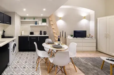 a kitchen with a table and chairs in a kitchen at Bocheńska 6 by Homeprime in Kraków