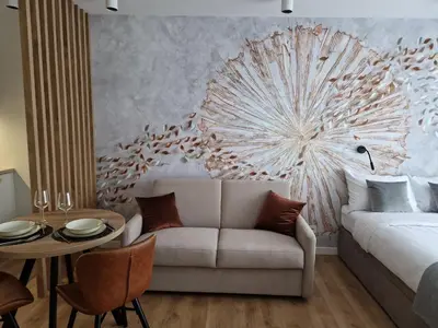 a bedroom with a bed and a table and a couch at Apartament Sunray in Kraków