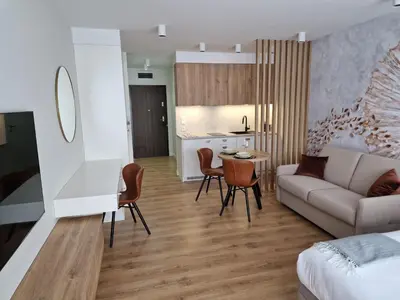 a living room with a couch and a table at Apartament Sunray in Kraków