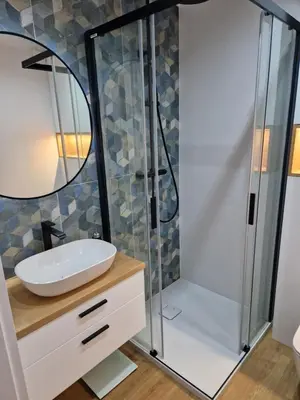 a bathroom with a sink and a shower at Apartament Sunray in Kraków