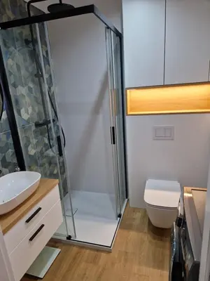 a bathroom with a shower and a toilet at Apartament Sunray in Kraków