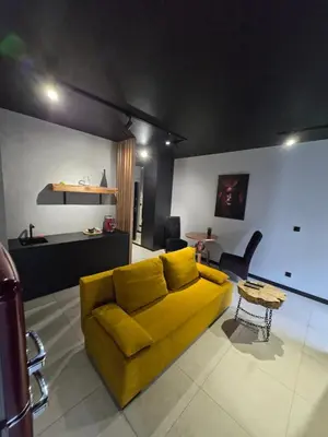 a living room with a yellow couch and a table at Design Vistula old town apartment private underground parking in Kraków