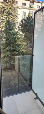 an open glass door with a view of a building at Design Vistula old town apartment private underground parking in Kraków