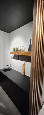a kitchen with a stove and a shelf with plants at Design Vistula old town apartment private underground parking in Kraków