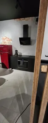 a kitchen with a stove top oven in a room at Design Vistula old town apartment private underground parking in Kraków