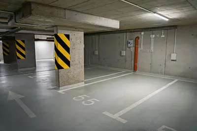 an empty parking lot in an empty parking garage at UR4N Apartment - Heltmana in Kraków