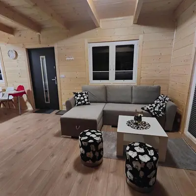 a living room with a couch and a table at beskid.house2 in Spytkowice