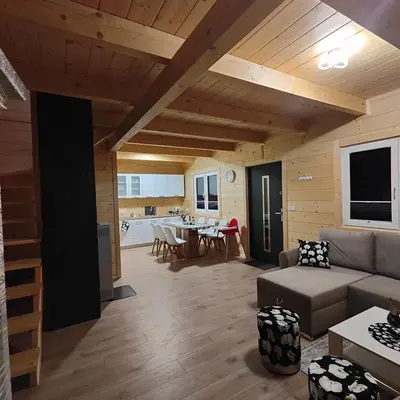 a living room with a couch and a table at beskid.house2 in Spytkowice