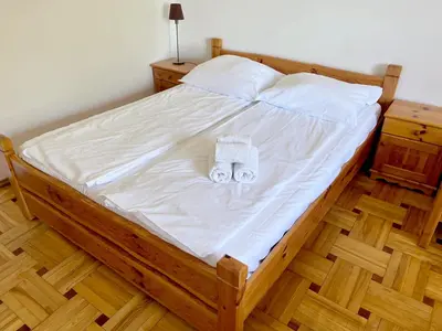 a large bed with white sheets and towels on it at Willa na Bani - apartamenty i pokoje in Rabka