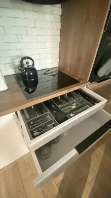 a tea pot sitting in the middle of a kitchen drawer at Apartament Złocień in Kraków