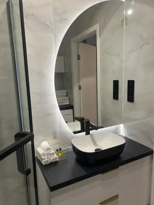 a bathroom with a sink and a mirror at Crystal Luxury Apartment with Free Parking in Cracow for 4 Guests in Kraków