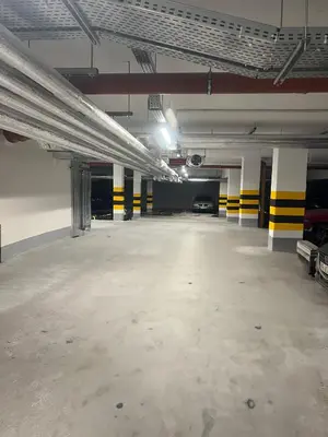 an empty parking garage with a parking lot at Crystal Luxury Apartment with Free Parking in Cracow for 4 Guests in Kraków