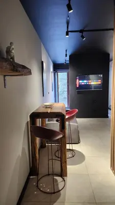 a room with two stools and a table and a television at Loft vistula old town apartament free parking in Kraków