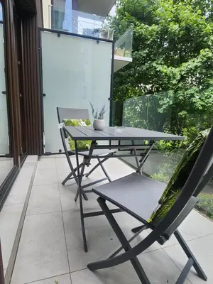 a table and two chairs on a patio at Loft vistula old town apartament free parking in Kraków