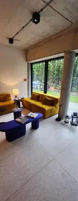 a living room with couches and tables and windows at Loft vistula old town apartament free parking in Kraków