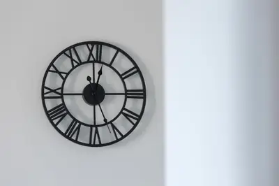 a black and white clock on a white wall at Bright Apartment Park Lotników Near Tauron Arena Kraków by Noclegi Renters in Kraków