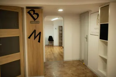 a hallway with a door with the letter m on it at Apartament 33 Skawina in Skawina