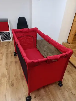a red chair sitting in a room at Apartament 33 Skawina in Skawina