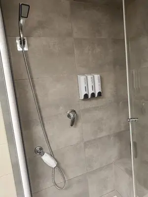 a shower with a glass door and a shower at Apartament 33 Skawina in Skawina